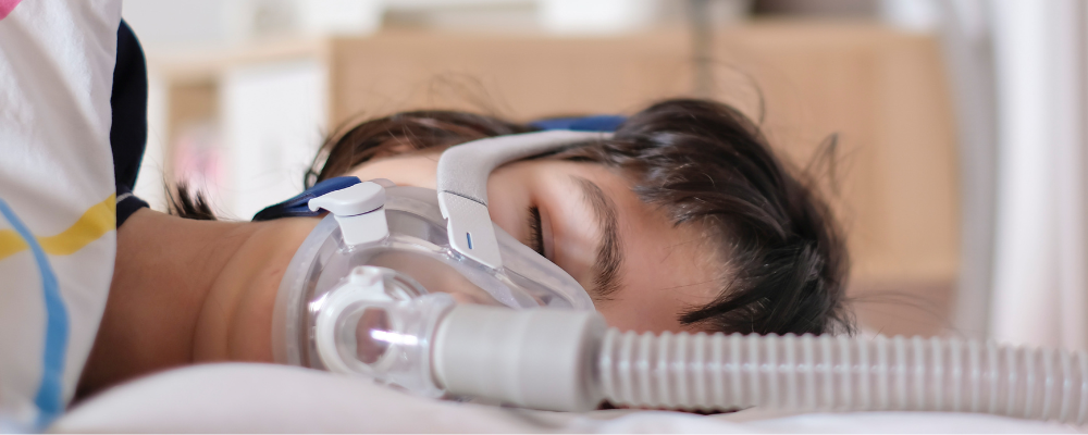picture of woman with central sleep apnea wearing a cpap mask