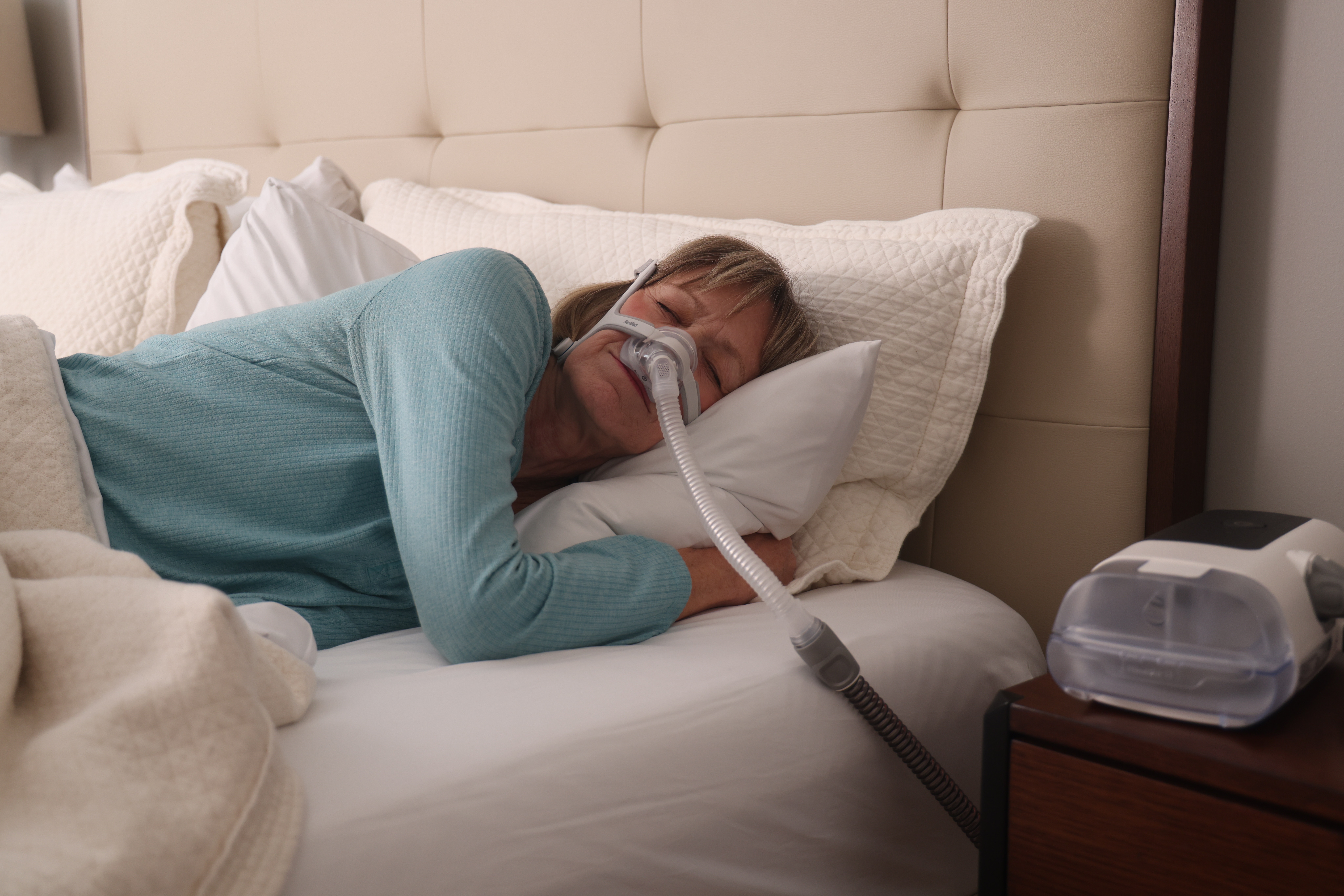 Women peacefully sleeping with a CPAP mask on 