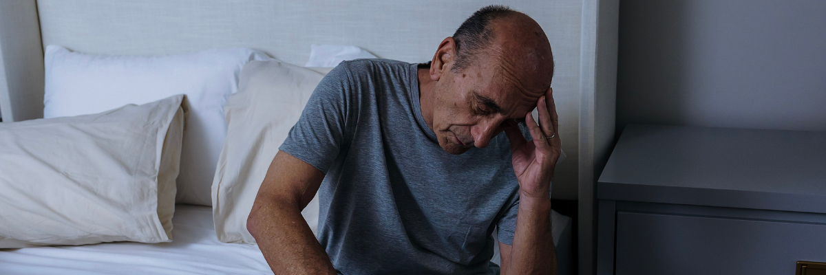 Aeroflow Sleep | Man sitting on bed thinking