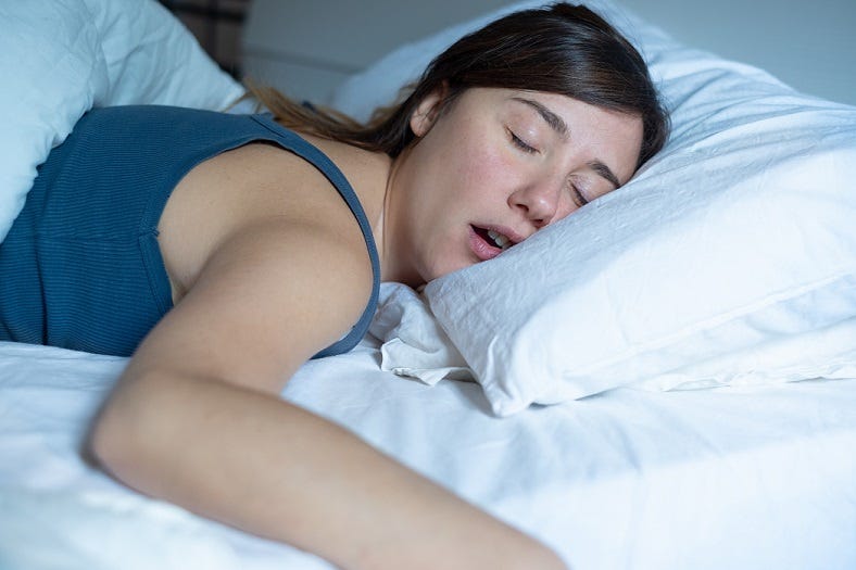 How to Sleep on Your Back, According to Sleep Experts